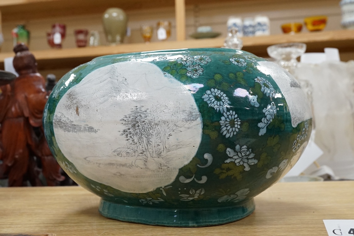 A Chinese enamelled porcelain oval bowl, Guandong kilns, early 20th century, green with en grisaille panels, 20cm high